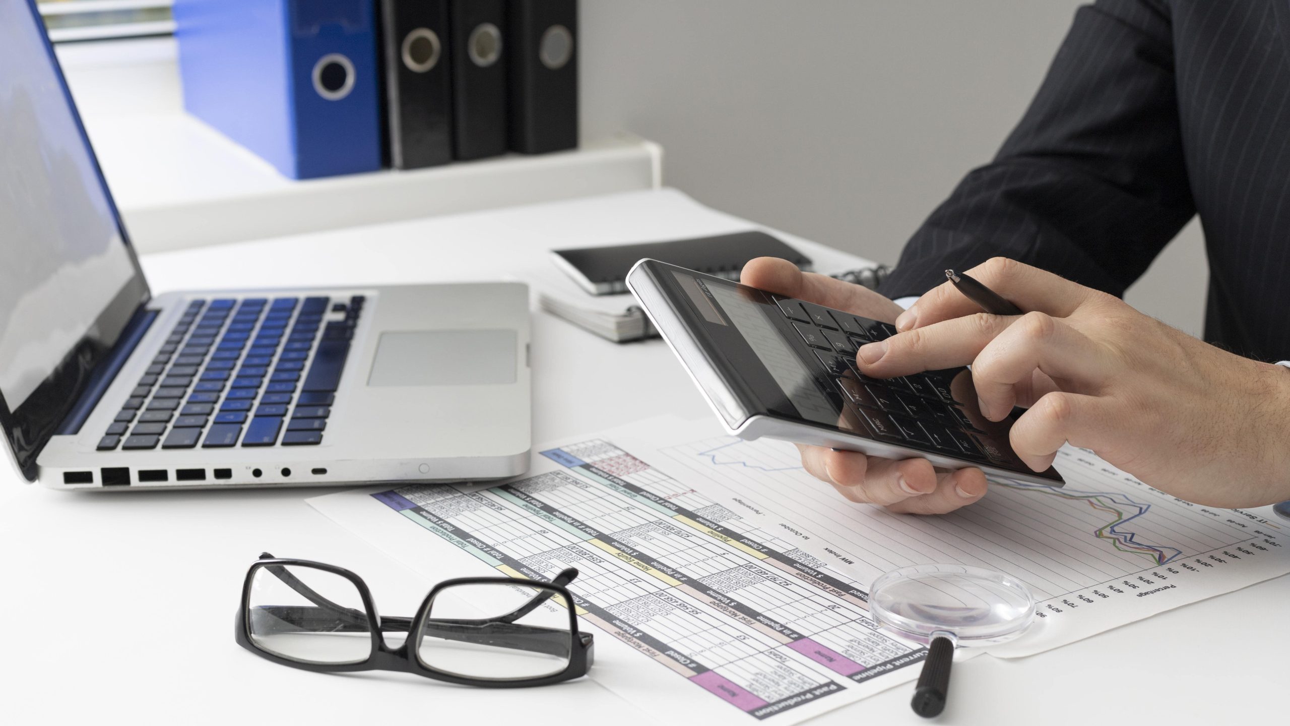 side view business man calculating finance numbers min scaled