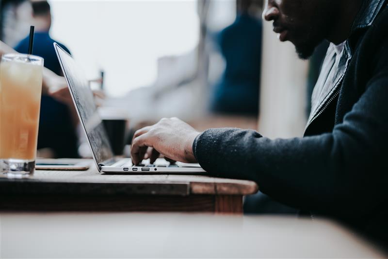 businessman working remotely from cafe